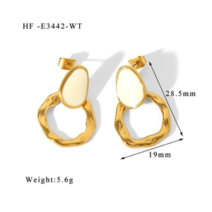 Macro shot of 18K gold plated earrings with white oval inlay and size dimensions