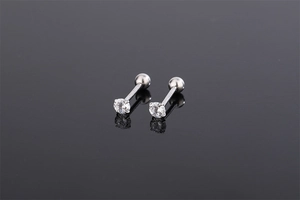Macro detail of S925 silver screw back ear studs with four-prong set round zircon