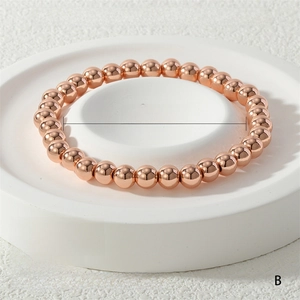 Detail view of 6mm rose gold elastic bead bracelet showing 17cm inner diameter and 24g weight