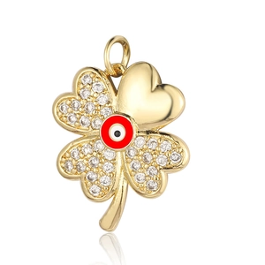 Detail of gold clover pendant with colorful evil eye and cubic zirconia inlay