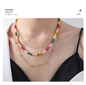 Detailed macro of layered necklace with freshwater pearls and colorful stone beads