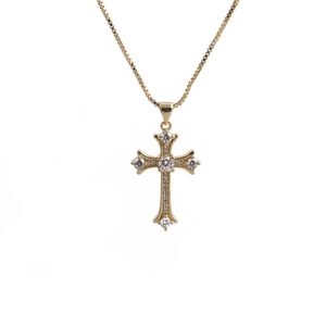 Close-up of golden cross pendant with sparkling zircons and delicate box chain detail