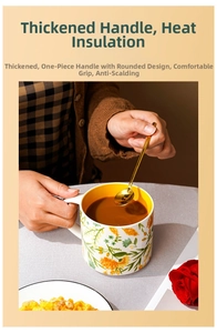 Detail of floral ceramic mug with thick heat-resistant handle and yellow glazed interior