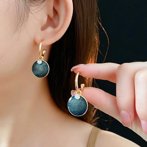 Vintage gold sunflower stud earrings with deep blue enamel and sparkling zircon detail