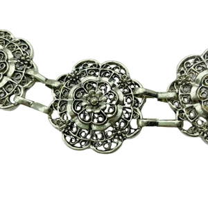 Vintage silver metal waist chain with intricately hollowed floral concho link patterns