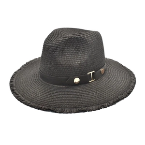 Detail of black straw fedora with frayed edges and leather band with gold hardware