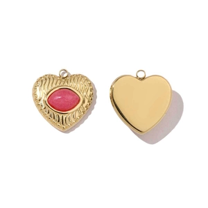 Detailed view of heart-shaped stainless steel pendant with pink stone and polished back