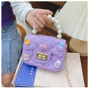 Close-up of girls purple jelly bag with pearl handle and 3D cartoon charms