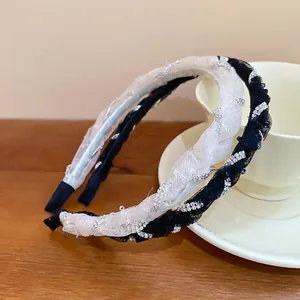 Elegant lace mesh headbands with diamonds and beads on a ceramic cup background