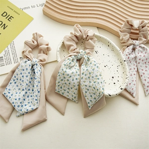Three-piece hair scrunchies set with long floral ribbons in blue, green, and pink colors