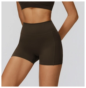 Detail of high-waisted dark brown yoga shorts with flatlock stitching and wide waistband