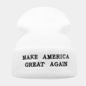 Detail of white knit beanie featuring black Make America Great Again embroidery on the cuff