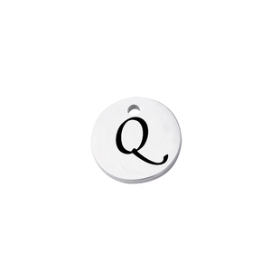 Macro view of mirror-polished silver stainless steel pendant with engraved letter Q