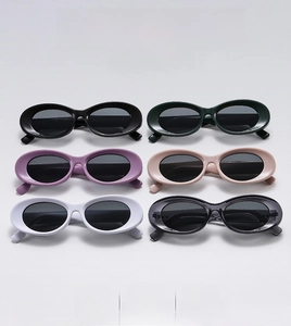 Macro detail of oval sunglasses in six colors including black, green, and white frames