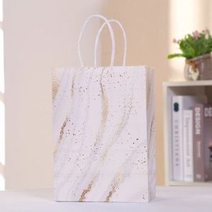 Close-up of marble pattern gift bag with gold veins and soft white cotton rope handle
