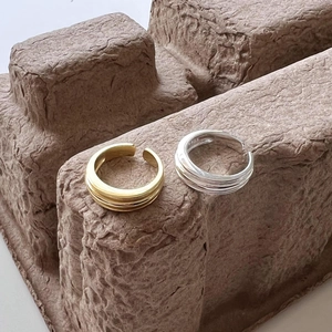 Close-up of gold and silver S925 sterling silver rings with layered band details