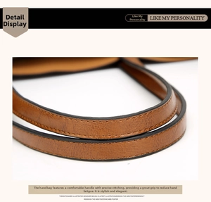 Close-up of brown textured leather straps with precise stitching and black edge finish