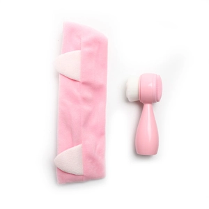 Pink cat ear headband and dual-sided facial cleansing brush set on white background