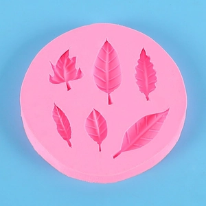 Pink round silicone mold featuring six diverse leaf patterns for fondant and DIY crafts