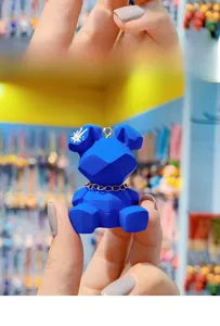 Close-up of blue faceted resin rabbit charm with gold chain and star detail on ear