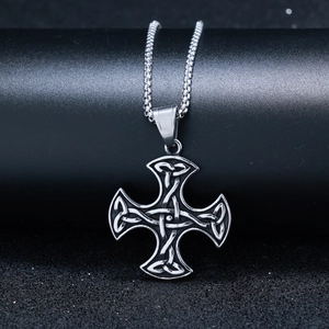 Detail of vintage silver Celtic cross pendant with intricate knotwork and a sturdy box chain