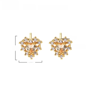 Macro view of heart-shaped brass earrings with clear AAA zircon and 18K gold plating
