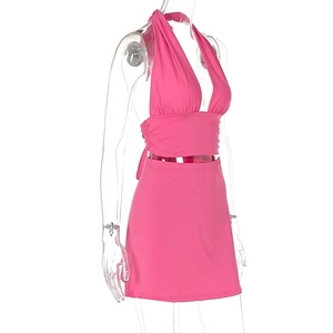 Detail of pink two-piece set featuring halter v-neck crop top and matching mini skirt