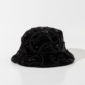 Detailed view of black quilted bucket hat featuring premium glossy finish and textures