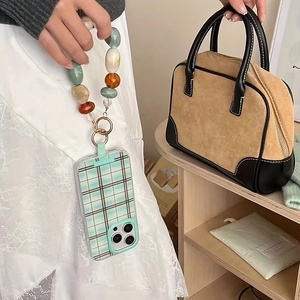 Green plaid phone case with chunky acrylic geometric beads and ethnic beaded lanyard