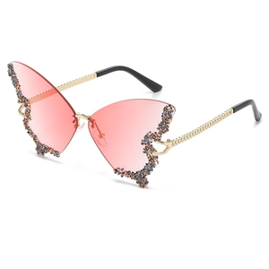 Occhiali da sole a farfalla senza montatura con lenti sfumate rosa e strass lucidi