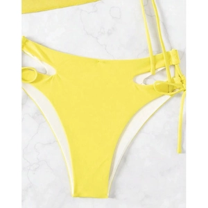 Detail of vibrant yellow high-waisted bikini bottom with side cut-outs and drawstrings
