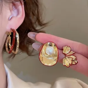 Waterdrop pearl petal diamond earrings in red and gold finish for women