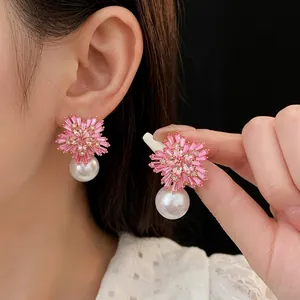 Pink flower earrings with diamonds and large round pearls in a luxury gold finish