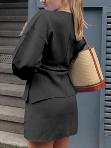 Women's black two-piece knit long sleeve top and skirt set shown from a back view outdoors