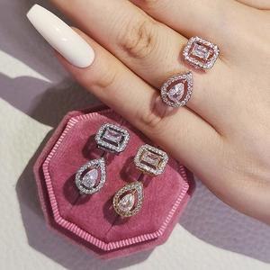 Detail showing elegant square and pear-cut zircon rings in gold and silver finishes