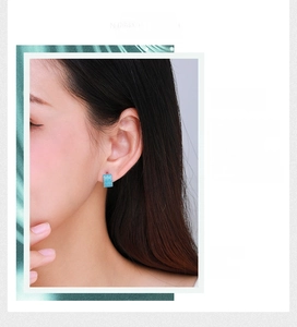 Close-up of s925 sterling silver turquoise stud earrings on female ear with minimalist style