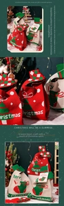 Detailed close-up of knitted Christmas gift bags with festive patterns and Merry Christmas tags