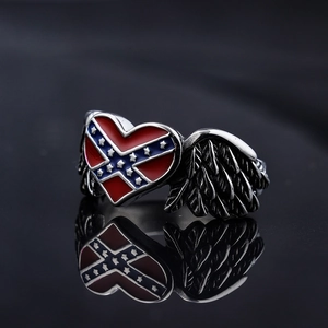 Vintage punk style winged heart ring with American flag enamel pattern on dark background
