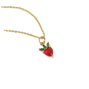 Élégant collier doré orné d'un pendentif fraise rouge vif avec détails de feuilles vertes