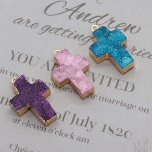 Detail of natural crystal cross pendants with golden edges and sparkling druzy textures
