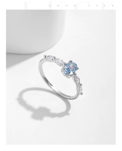 Macro shot of S925 sterling silver ring featuring oval blue opal and marquise accents