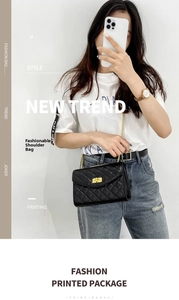 Detail of classic black quilted chain bag featuring a square gold metal twist lock
