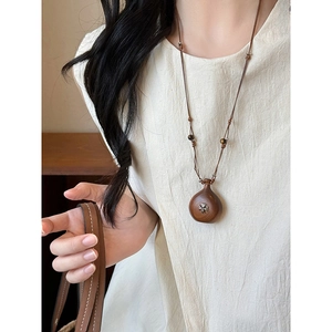Ethnic style wooden heart gourd necklace with metal floral inlay and cord chain