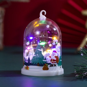 Detail of Christmas night light with LED tree and Santa Claus in a glass dome
