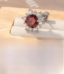 Detail showing red stone flower stud with titanium screw back and zircon pavé petals
