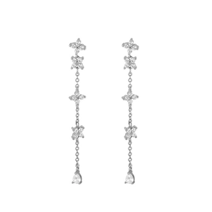 Detail of silver long chain tassel earrings with floral motifs and teardrop gemstones
