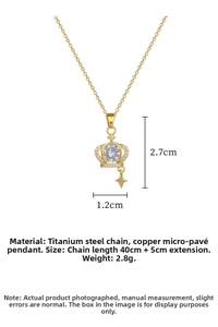 Macro detail of gold crown pendant with sparkling crystals and titanium steel chain