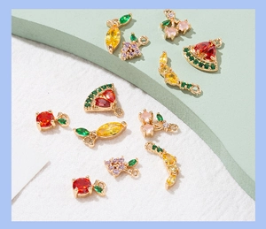 Macro shot of assorted micro-pave fruit pendants with colorful zirconia on gold bases