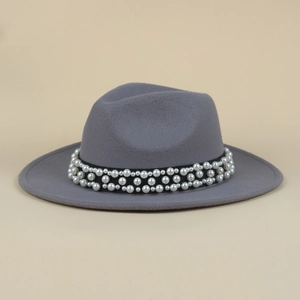 Detail of grey wool fedora hat featuring a black ribbon band adorned with elegant pearls