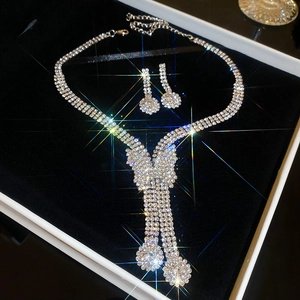 Close-up of sparkling rhinestone tassel necklace and earrings set in a gift box